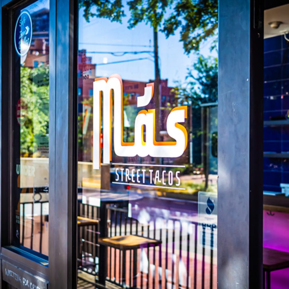 The Mas Street Tacos logo is prominently displayed on the glass entrance of the restaurant.